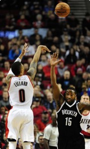 Portland Trail Blazers guard Damian Lillard (0) hits a shot over Brooklyn Nets guard Donald Sloan (15) during the first half of an NBA basketball game in Portland, Ore., Tuesday, Feb. 23, 2016. (AP Photo/Steve Dykes) 