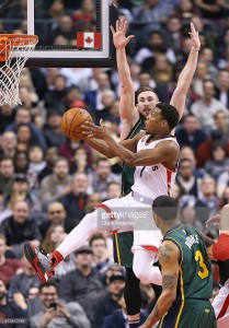 Kyle Lowry #7 of the Toronto Raptors goes up for a basket against Gordon Hayward #20 of the Utah Jazz during an NBA game at the Air Canada Centre on March 2, 2016 in Toronto, Ontario, Canada. The Raptors defeated the Jazz 104-94. March 02, 2016| Credit: Claus Andersen