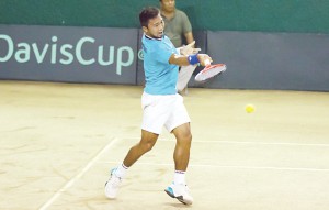 Jeson Patrombon returns a volley from Kuwait’s Abdulhamid Mubarak during their reverse singles match of their Davis Cup Asia Oceania Zone Group II first round tie at the Valle Verde Country Club in Pasig City yesterday. (Federico Cruz) 