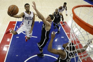 (AP Photo/Matt Slocum). Philadelphia 76ers' Ish Smith, left, goes up to shoot against Brooklyn Nets' Brook Lopez during the second half of an NBA basketball game, Friday, March 11, 2016, in Philadelphia 