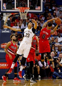 New Orleans Pelicans forward Anthony Davis (23) fails to keep a rebound away from Portland Trail Blazers guard Damian Lillard (0) during the the first half of an NBA basketball game in New Orleans, Friday, March 18, 2016. (AP Photo/Max Becherer)