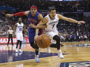 Pistons forward Tobias Harris (34) and Hornets guard Jeremy Lin (7) chase down a loose ball arm-in-arm during the second half of the Pistons' 118-103 loss Friday in Charlotte, N.C.  Bob Leverone AP