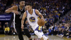 Warriors' Stephen Curry (30) dribbles past San Antonio Spurs' Tim Duncan during an NBA basketball game Thursday, April 7, 2016, in Oakland, Calif. (AP Photo/Marcio Jose Sanchez)