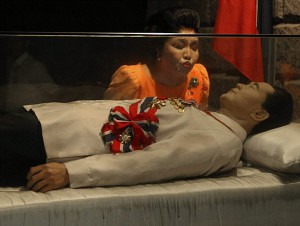 Former First Lady Imelda Marcos kisses the glass coffin with the preserved remains of Ferdinand Marcos
