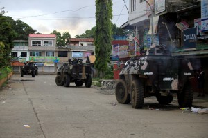 An Armoured Personnel Carrier is seen on a main street of Datu Javier village as the government troops continue to assault the Maute group in Marawi city