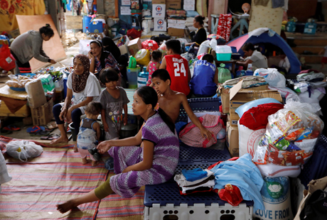 Evacuated residents rest at an evacuation centre in Iligan